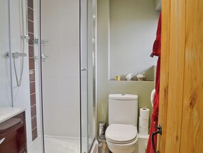 A bathroom with a glass shower enclosure, a toilet, and a sink. - 2 bedroom accommodation in Sproughton (Sproughton)
