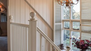 A staircase with white railings and a window with shutters. - 2 bedroom accommodation in Ilketshall St. Margaret, near Bungay (Ilketshall St. Margaret, near Bungay)