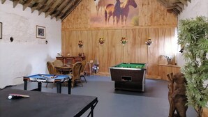 A room with a pool table, a billiards table, and a foosball table. There are wooden walls and a wooden ceiling. - Old Barn Farm Cottage - CC539048 (Uplawmoor, near Paisley)