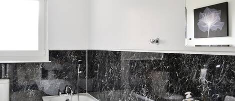 A bathroom with a bathtub, a shower, a toilet, and a sink.