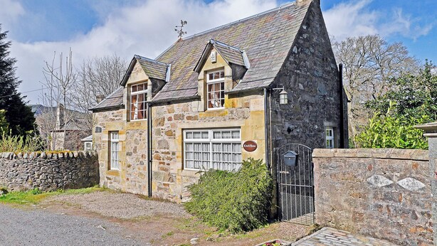 A stone building with a steeply pitched roof, a chimney, and a sign that reads "Cottage House." - 2 bedroom accommodation in Birnam, near Dunkeld (Birnam, near Dunkeld)