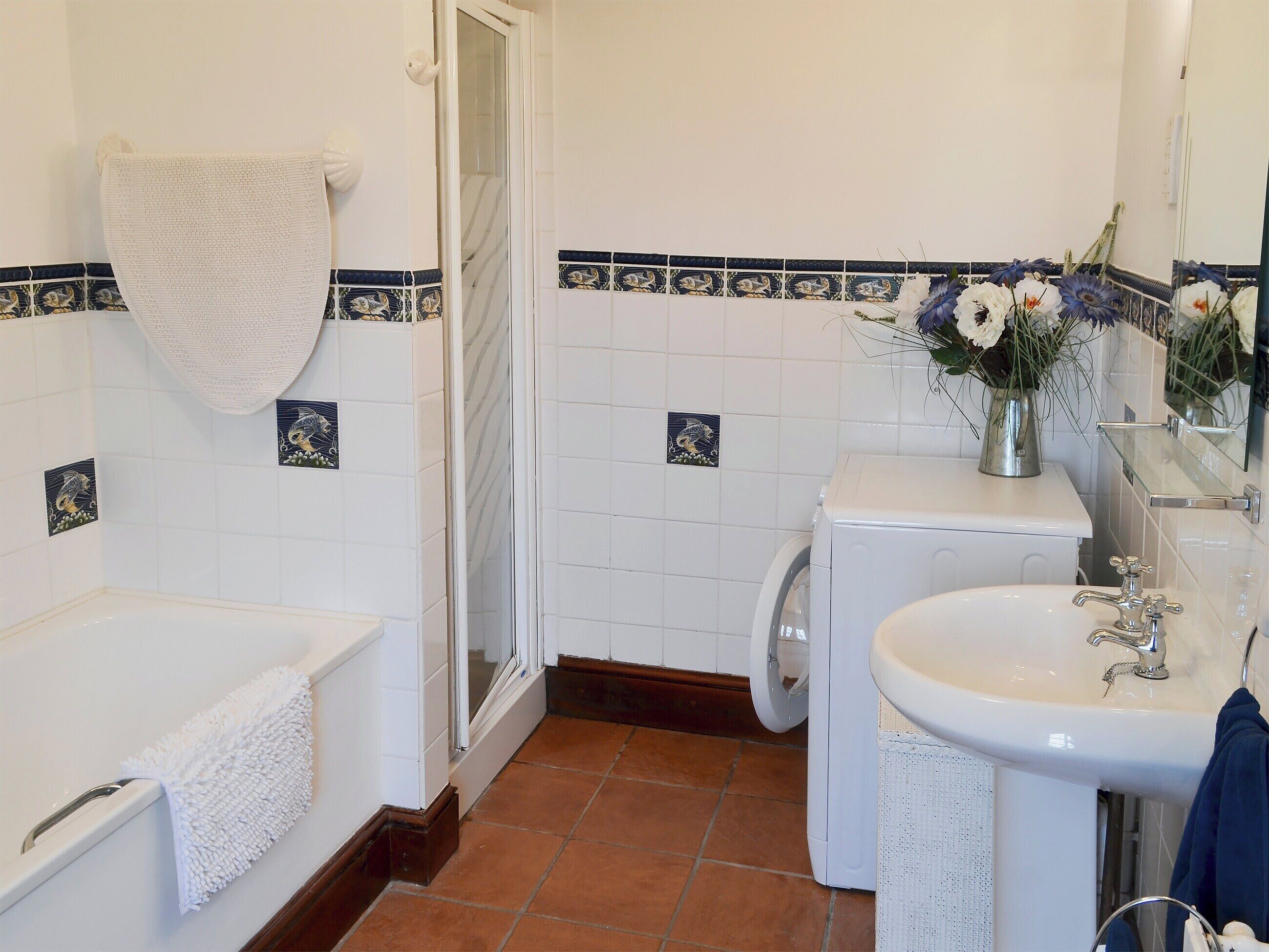 A bathroom with a bathtub, a toilet, and a sink.