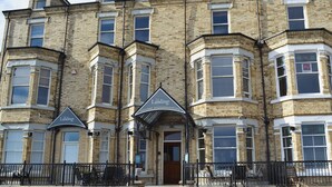 A multi-story building with a prominent sign for 'The Landings Holiday Accommodation'.