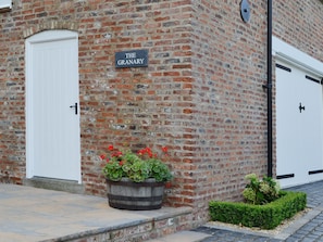 A brick building with a sign reading "The Granary."