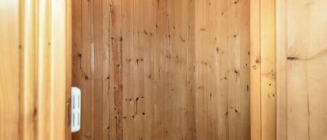 A sauna with wooden walls, benches, and a visible heater.