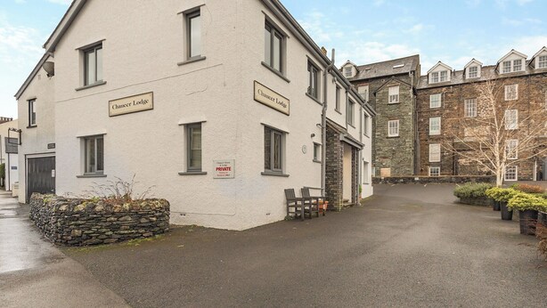 A building labeled "Chaucer Lodge" with a sign indicating "PRIVATE Parking Only." - Short breaks available all year. (Keswick)