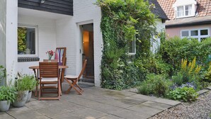 A house with a patio, a table, and chairs.