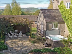 A garden with a hot tub, white outdoor furniture, and a stone pathway. - Purcombe Farmhouse - 28458 (Whitchurch Canonicorum, near Bridport)
