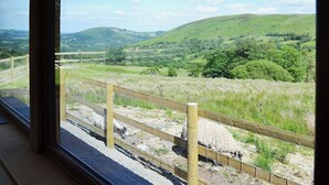A view of a rural landscape with rolling hills and a fenced area. - 3 bedroom accommodation in near Llanwrthwl, Powys (near Llanwrthwl, Powys)