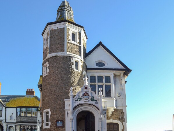 A historic building with a prominent tower and a traditional entrance.