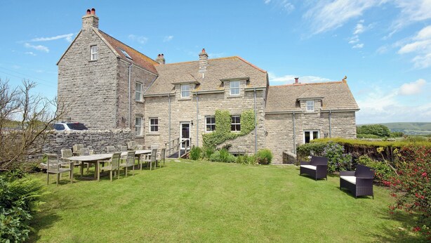 A stone house with a large lawn and outdoor seating area. - 7 bedroom accommodation in Acton, near Langton Matravers (Acton, near Langton Matravers)