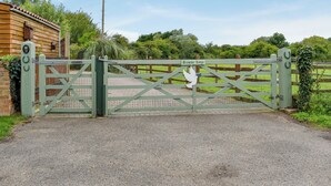 A gated entrance to a property with a wooden fence and a sign that reads "Branley Lodge."