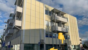 A modern multi-story building with large windows and balconies. - Wherever Boutique Hostel (Rovaniemi)