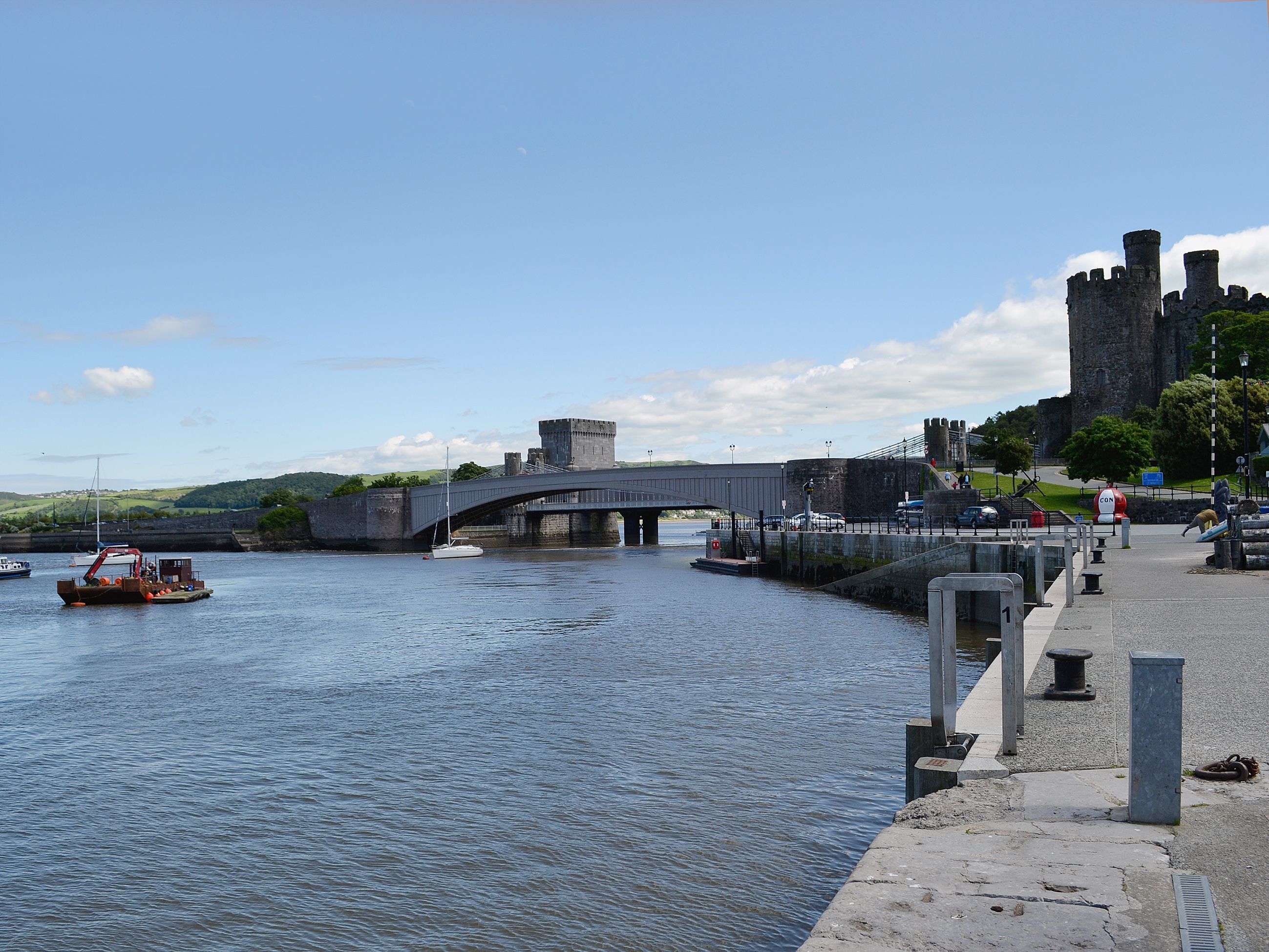 A bridge over a river with a castle in the background.