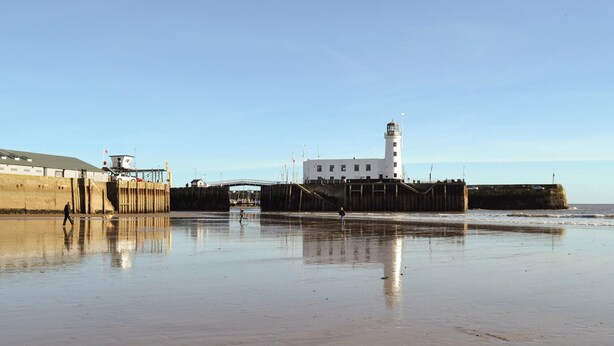 A coastal scene with a lighthouse, a pier, and a sandy beach. - All on the Ground Floor: 
Open plan living space. (near Kirkbymoorside)