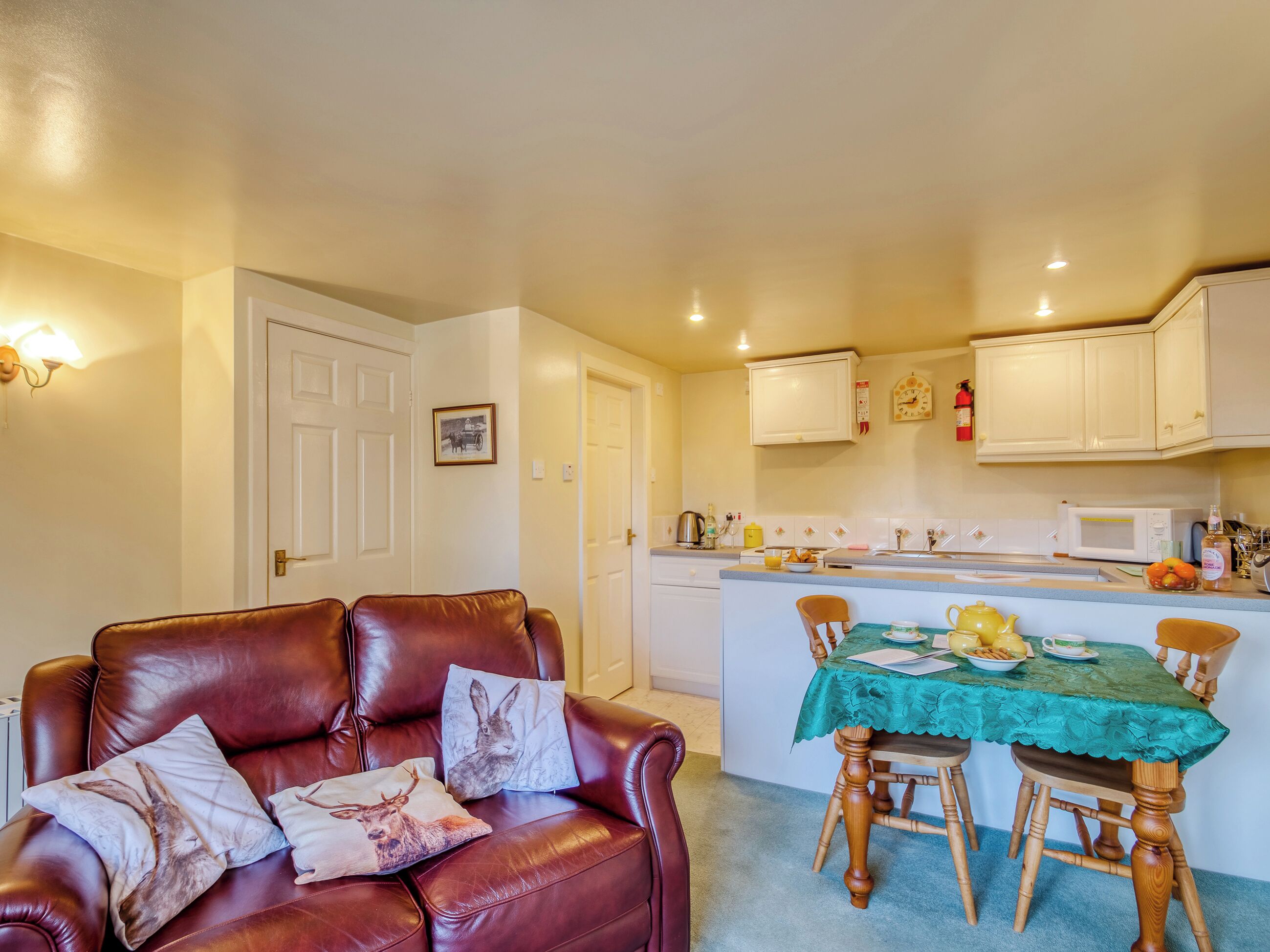 A compact living space with a dining area and kitchenette.