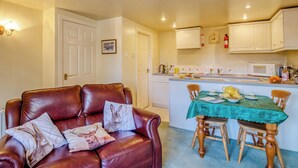 A compact living space with a dining area and kitchenette. - 1 bedroom accommodation in Goldsborough, near Harrogate (Goldsborough, near Harrogate)