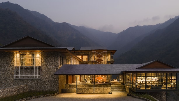 A modern house with a stone facade, a wooden deck, and a glass-enclosed library. - Taj Rishikesh Resort & Spa, Uttarakhand (Narendranagar)