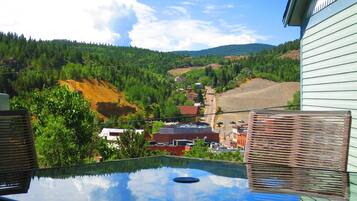 Enjoy breathtaking views of the surrounding landscape from this balcony.