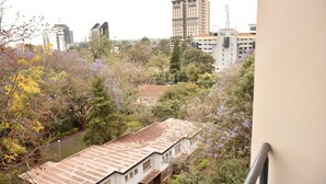 A view of a cityscape with buildings, trees, and a river. - Sherry Homes Raha Westlands (Nairobi)