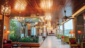 A spacious lobby with wooden ceiling, large windows, and multiple seating areas. - The Argyle (Hatton)