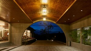 An indoor area with a vaulted ceiling, stone flooring, and a view of the night sky. - The Argyle (Hatton)