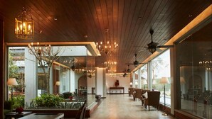 A spacious, modern dining area with wooden flooring, large windows, and elegant chandeliers. - The Argyle (Hatton)