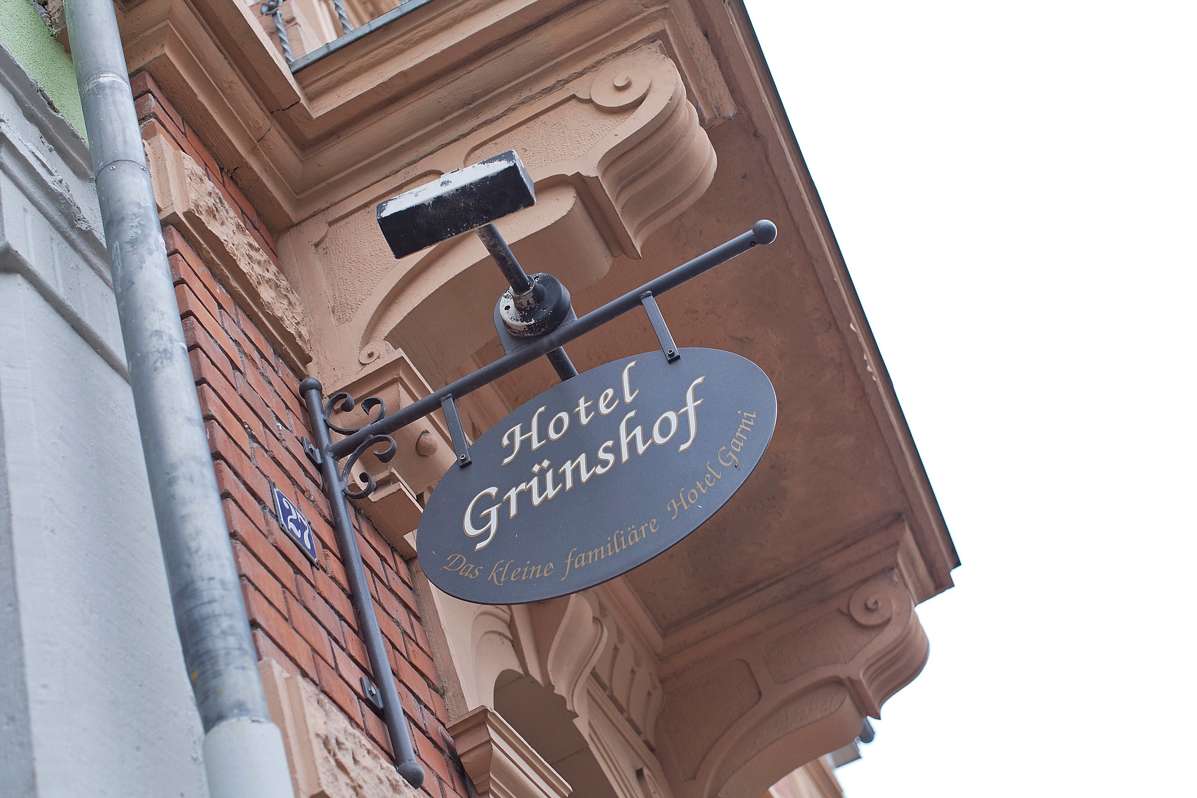 A hotel sign with the name "Hotel Grunshof" and the phrase "Das Kleine familiäre Hotel."