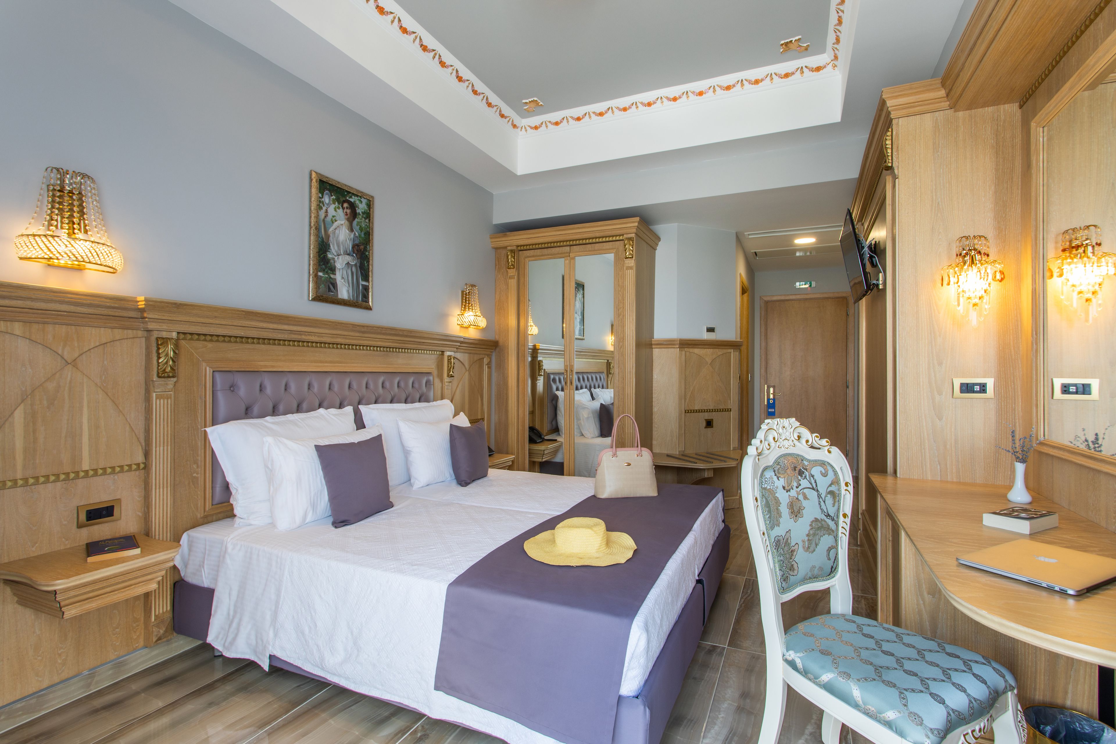 A well-appointed bedroom with a large bed, a desk, and a chair.
