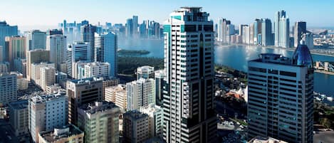 A high-rise urban area with modern buildings, a river, and a marina.