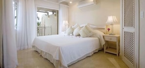 Relax in a spacious room with a large bed, two bedside tables, and lamps.