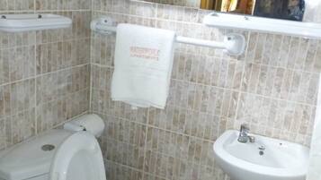 Combined shower/bathtub, deep-soaking bathtub, towels