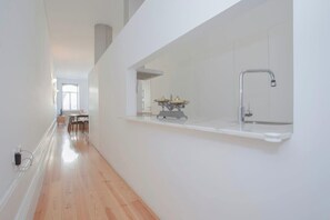 A modern kitchen with a built-in sink and a window above the countertop.