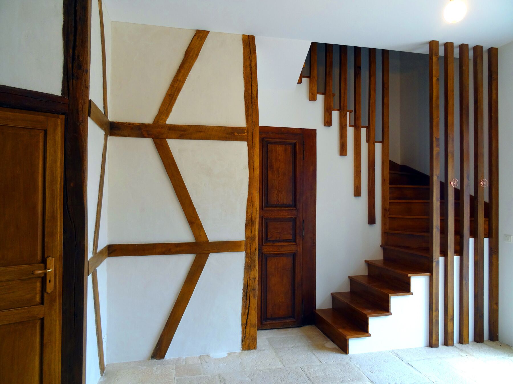 A staircase with wooden steps and a geometric wall design.