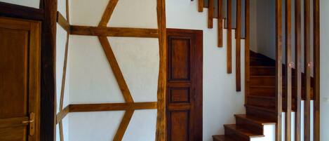 A staircase with wooden steps and a geometric wall design.