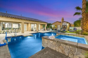 A swimming pool with a basketball hoop, lounge chairs, and a covered patio area. - Azul: Pool, Spa, Fire Pit and Pickle Ball Court! (Indio)