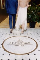 A marble floor with a logo for St. Thomas Hotel.