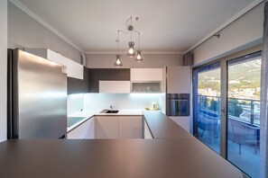 Superior Apartment, 3 Bedrooms, Sea View | Private kitchen | Coffee/tea maker, electric kettle, highchair - Hotel Harmonia by Dukley (Budva)