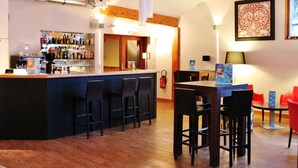 A bar area with a counter, stools, and a seating area with tables and chairs. - VVF La Plagne Montchavin Paradiski (La Plagne-Tarentaise)