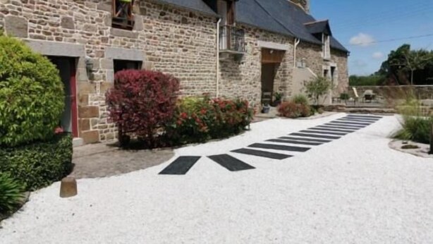 A stone building with a gravel driveway and a crosswalk leading to the entrance. - Mont Voyageur (Sains)