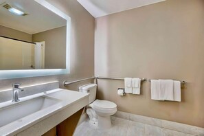 A bathroom with a sink, toilet, and towel rack.