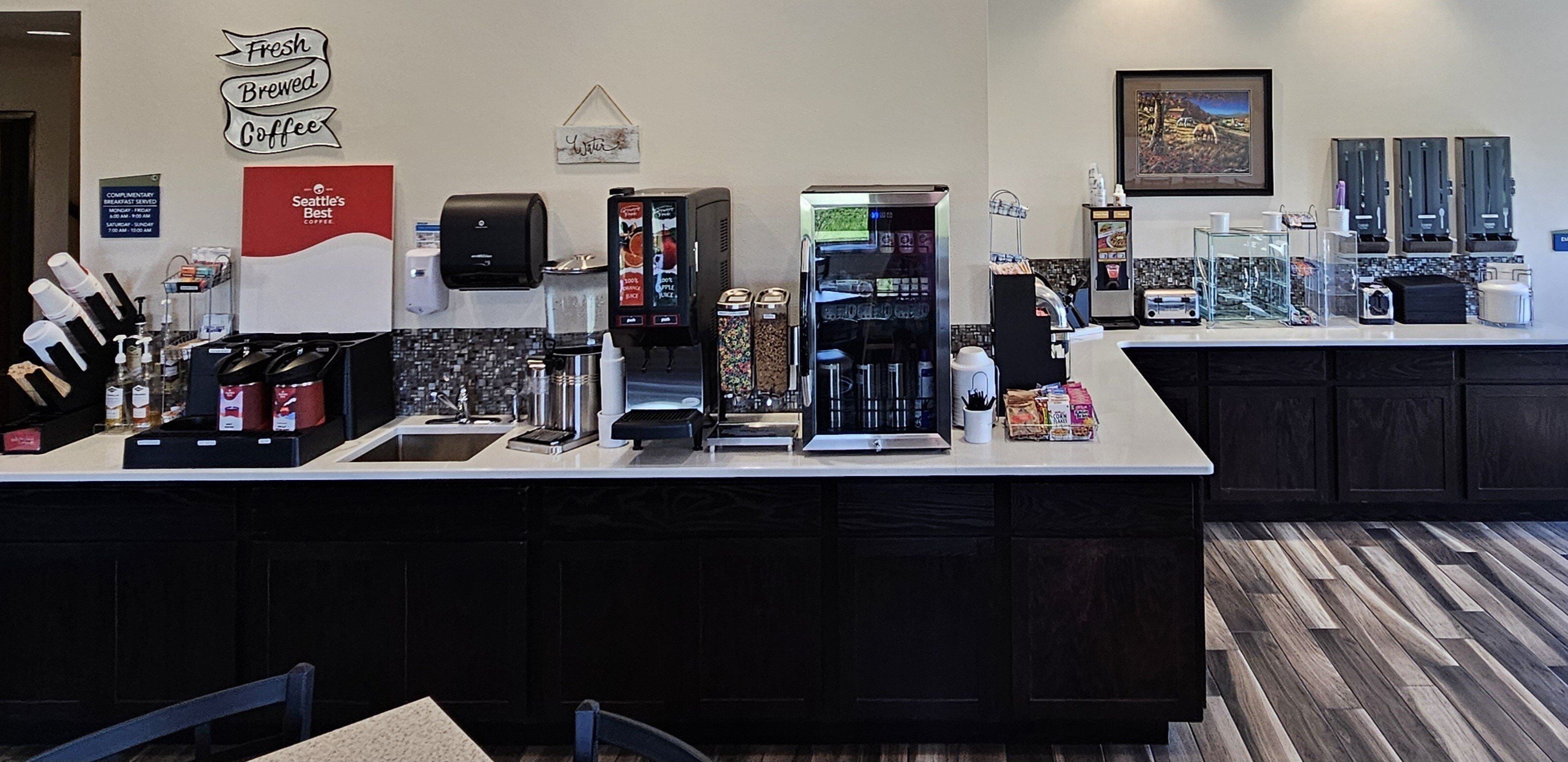 A coffee shop counter with various coffee machines, a menu board, and a sign that reads "Seattle's Best Coffee".