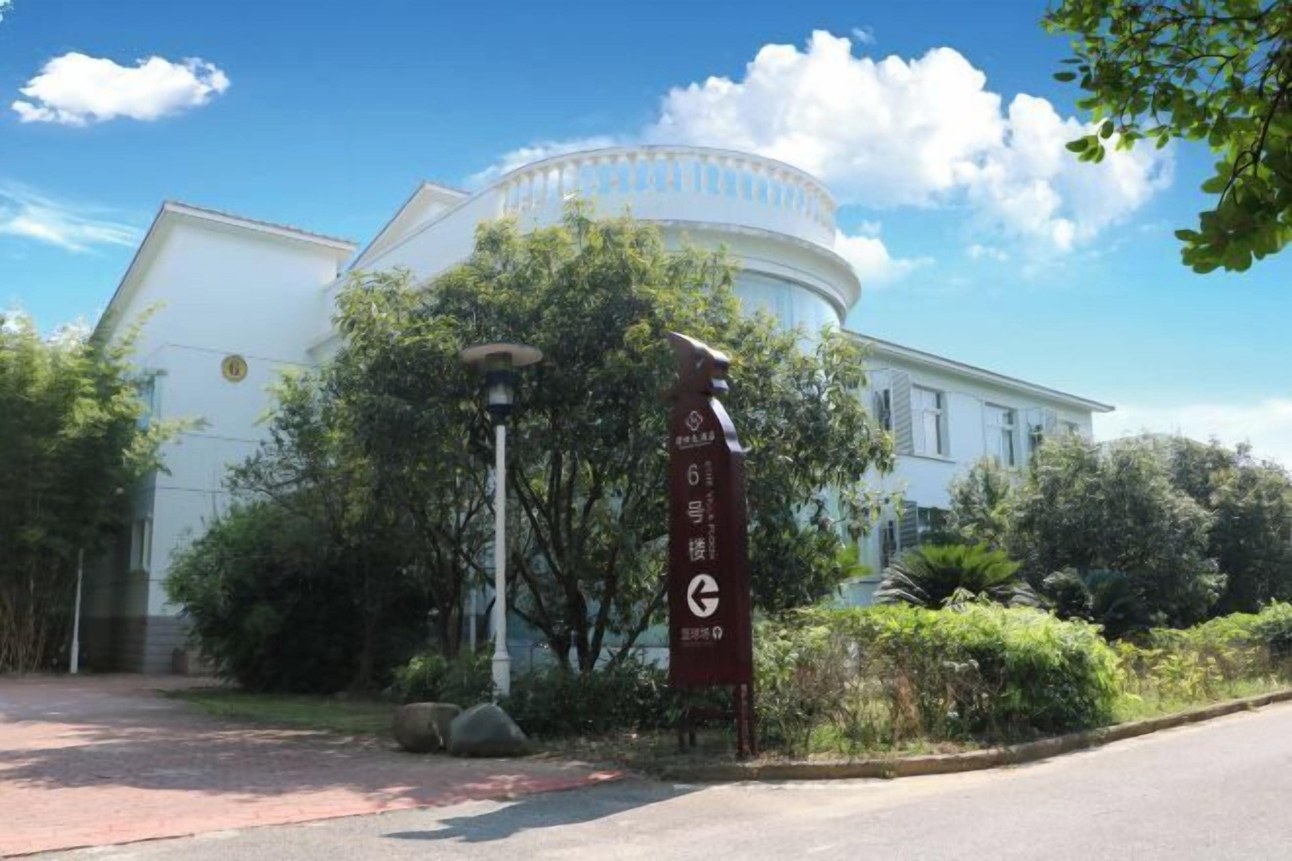 A building with a circular central section and a rectangular extension.
