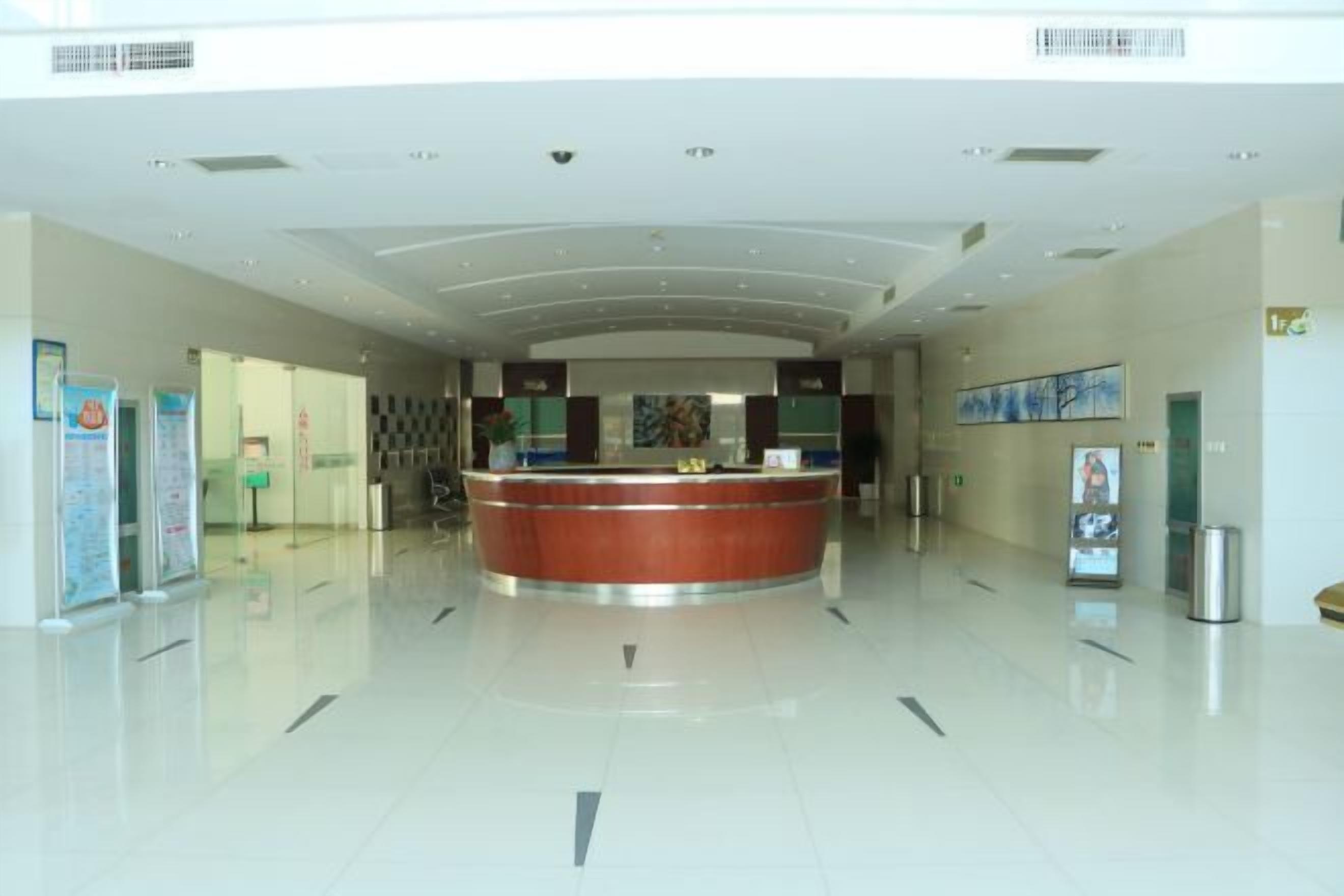 A spacious lobby with a central reception desk, clear signage, and a clean, modern design.