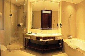 A modern bathroom with a glass-enclosed shower, a large vanity with dual sinks, and a separate bathtub. - Hetian Hotel (Wuhan)