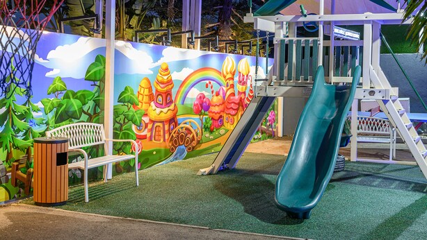 A playground with a slide, climbing area, and a bench. - Ahuzat Maya (Ma'ale Yosef)