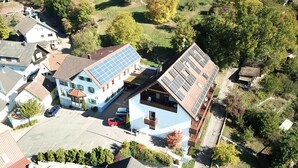 A residential area with houses, including one with solar panels and a visible garage. - Hotel Restaurant Kaiser (Herrenberg)