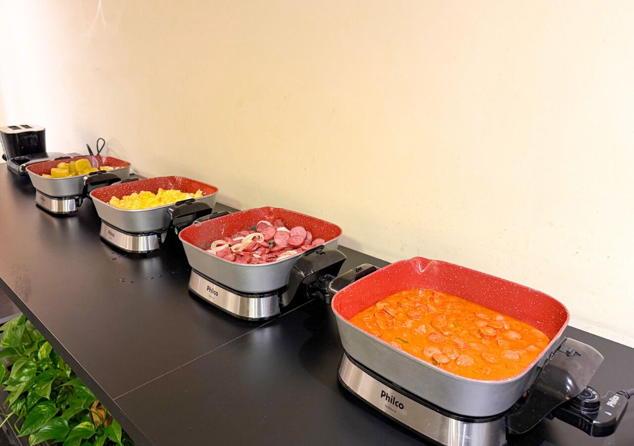 A buffet line with various food items in metal containers.