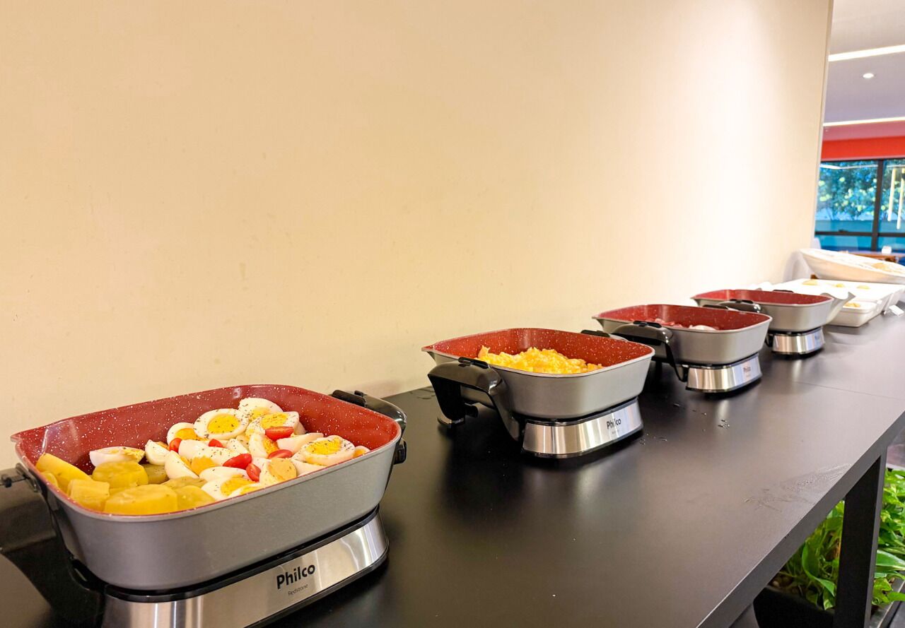 A buffet setup with various food items in metal containers.