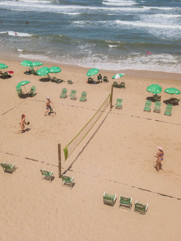 On the beach, white sand, beach umbrellas, beach towels